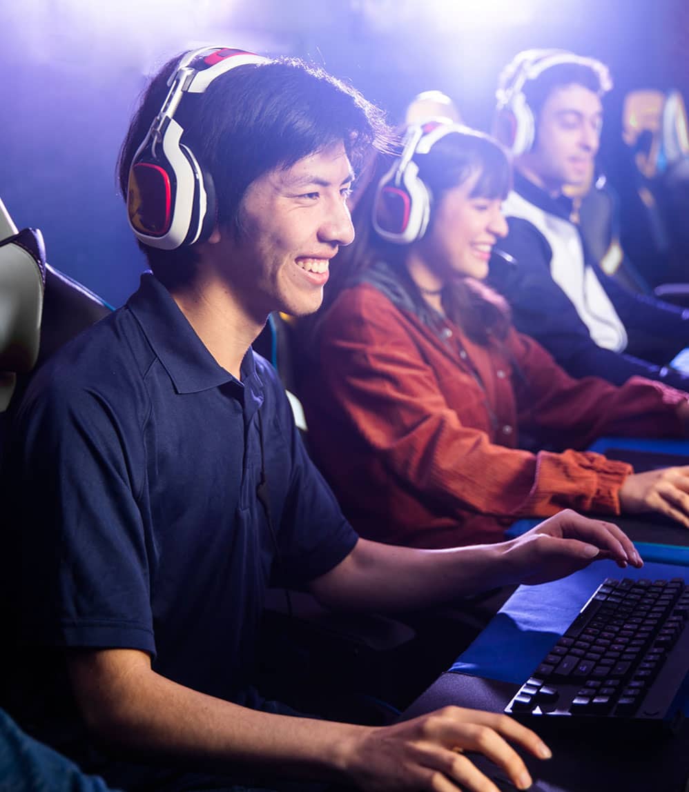 Colleagues having team-building session by playing esports game together on computers